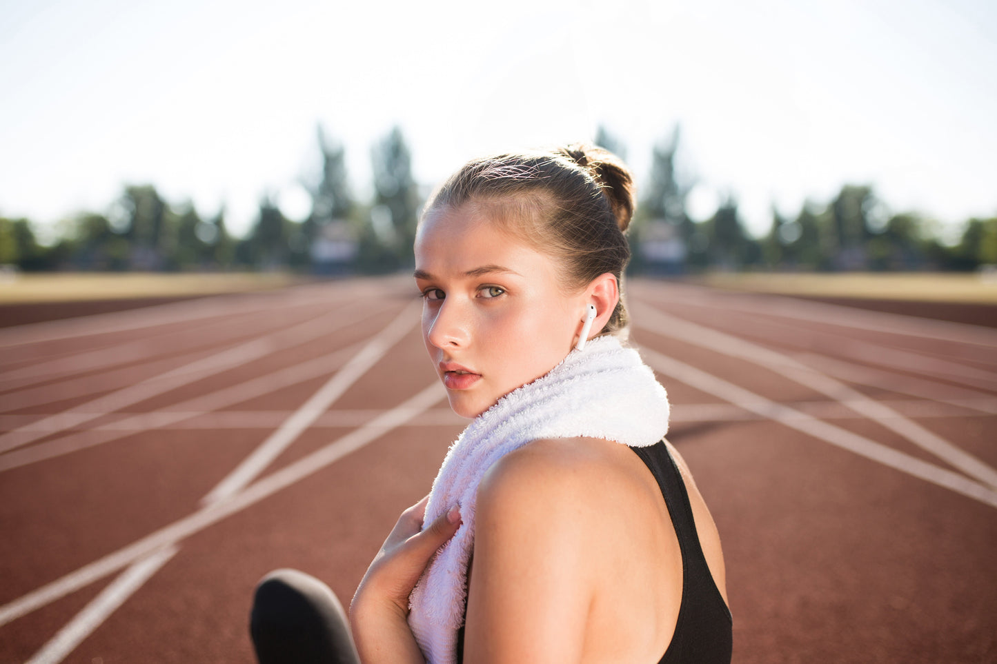 female runner at track takes a breather