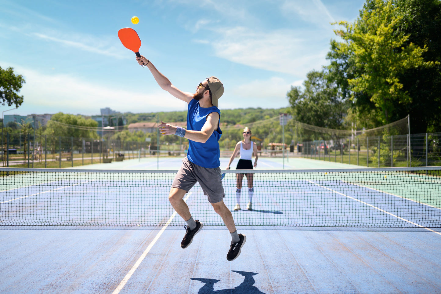 couple playing raquet sport on sunny day