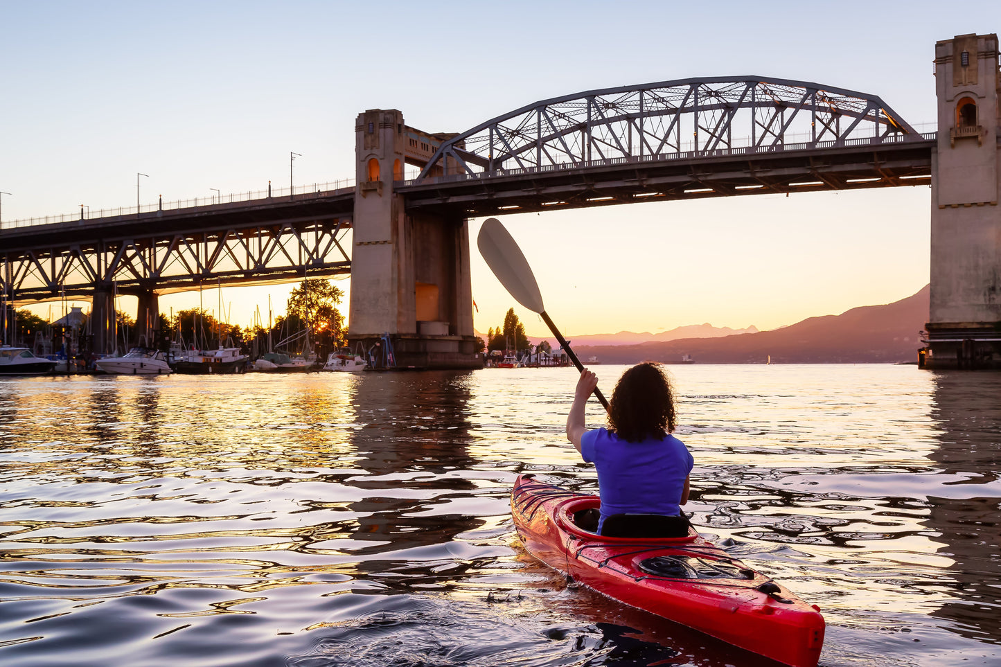 girl kayaking at sunset