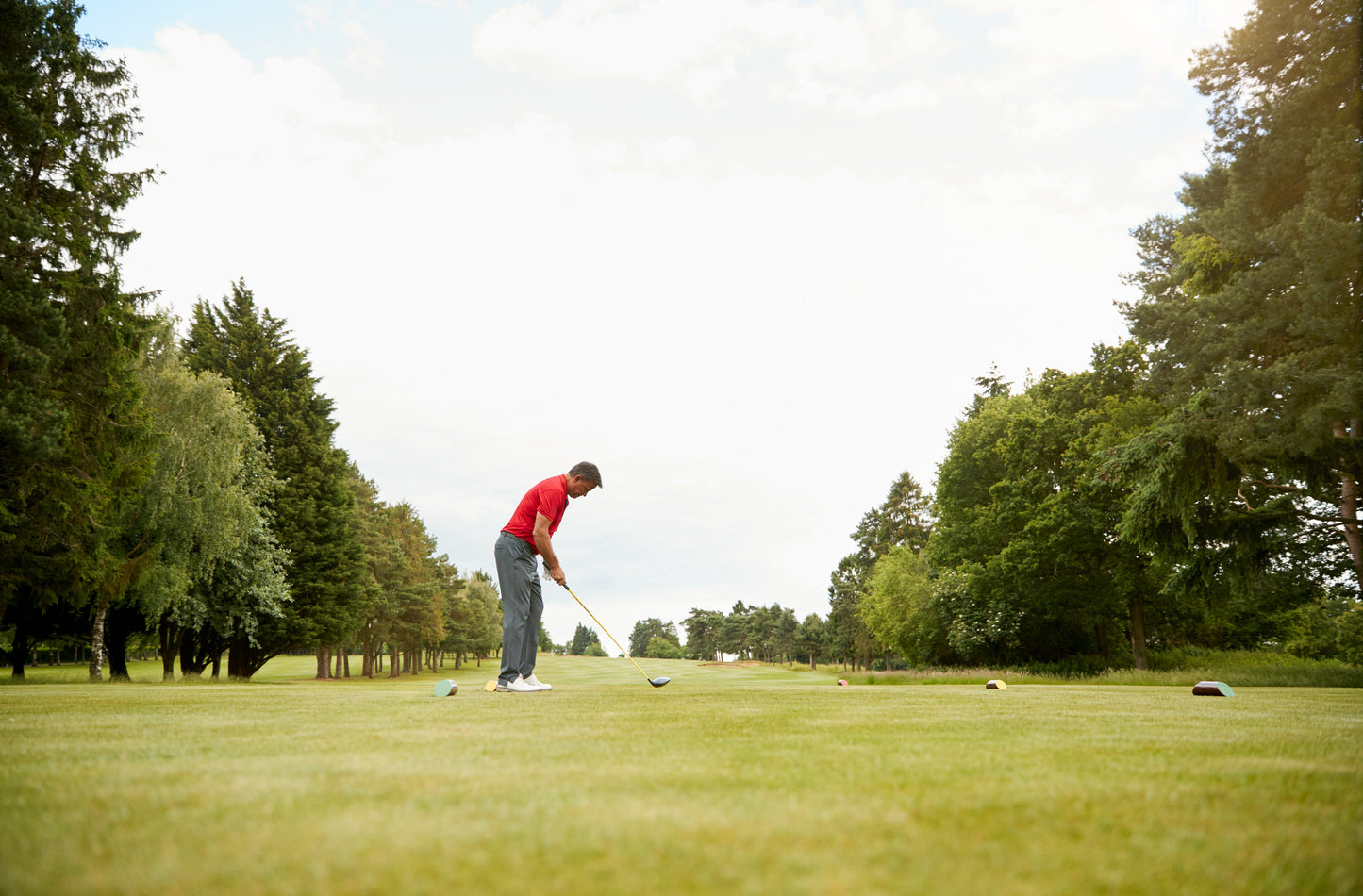man playing golf on beautiful day