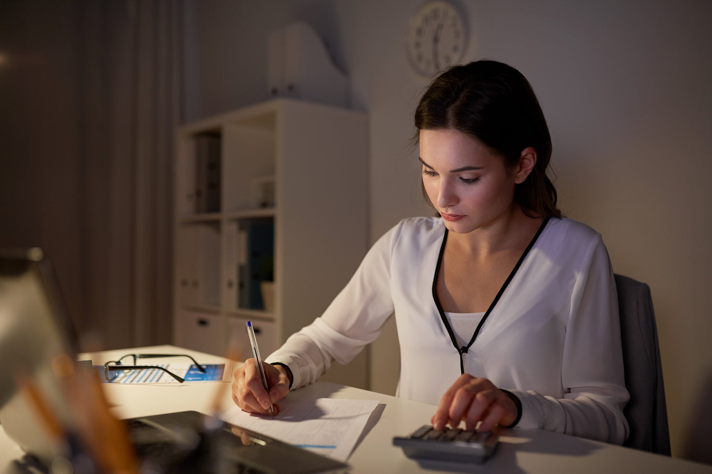 woman at table writing